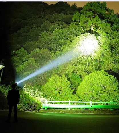 Adjustable Rechargeable Waterproof LED Flashlight by Stevvex beams across night forest on Tampa Home & Garden Store