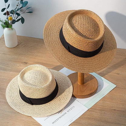 Stevvex straw fedora hat, beige wide-brim with black ribbon; two hats on wood table on Tampa Home & Garden Store