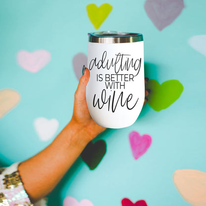 Adulting 17oz tumbler white cup with black script reading adulting is better with wine on Tampa Home & Garden Store