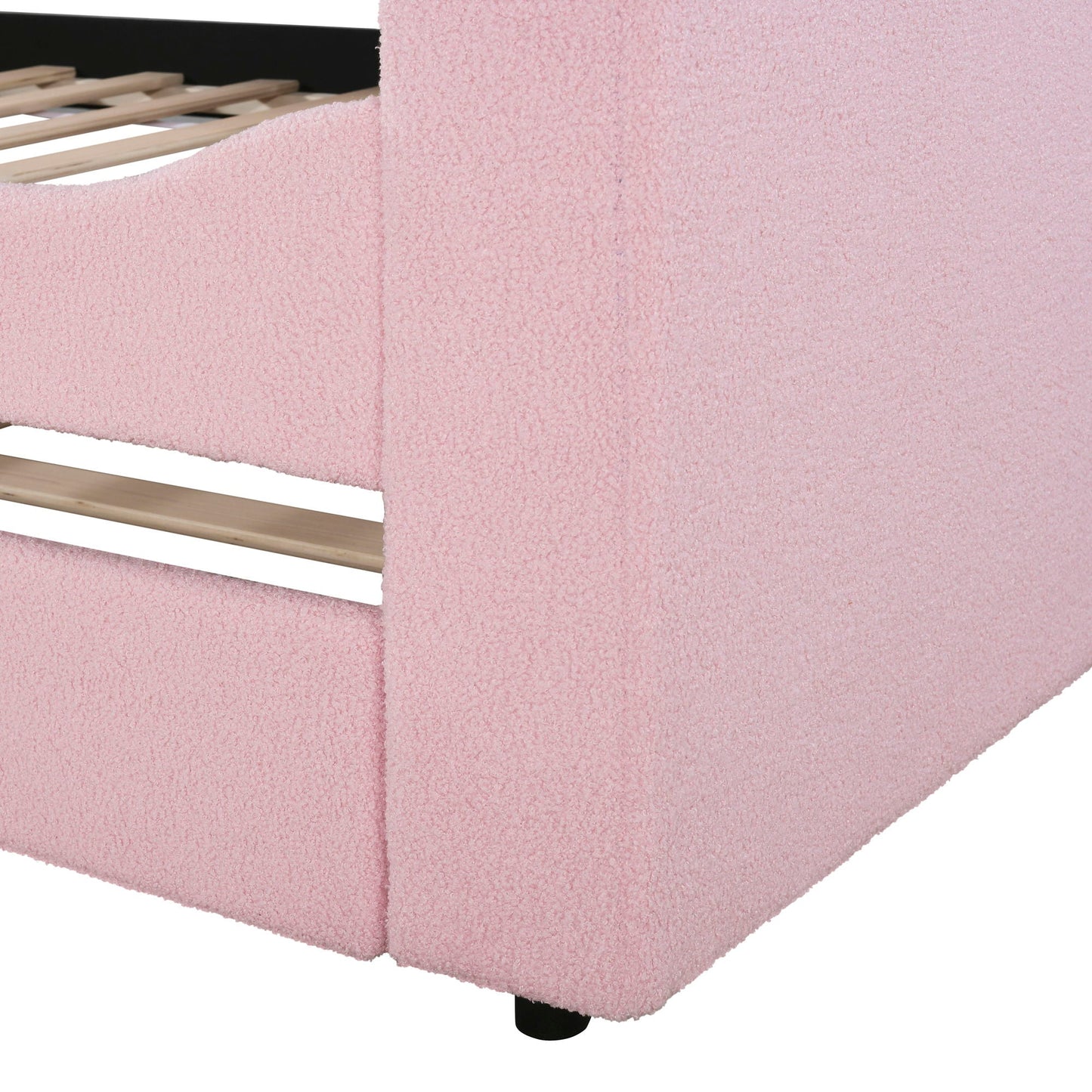 Upholstered daybed frame with pink fabric, visible slats and black legs on Tampa Home & Garden Store