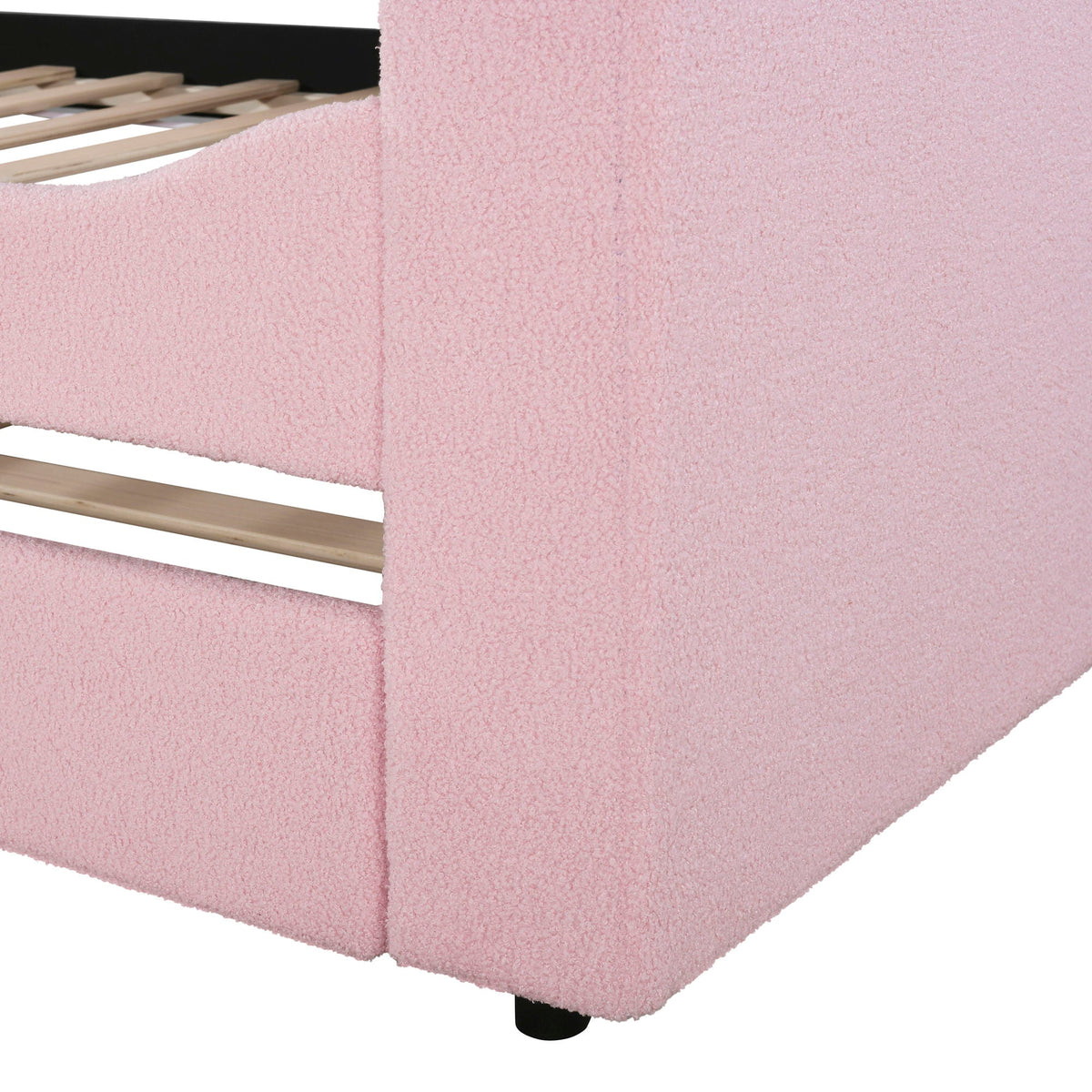 Upholstered daybed frame with pink fabric, visible slats and black legs on Tampa Home & Garden Store