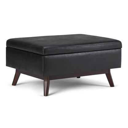 Owen upholstered rectangular storage ottoman in black faux leather with wood legs on Tampa Home & Garden Store