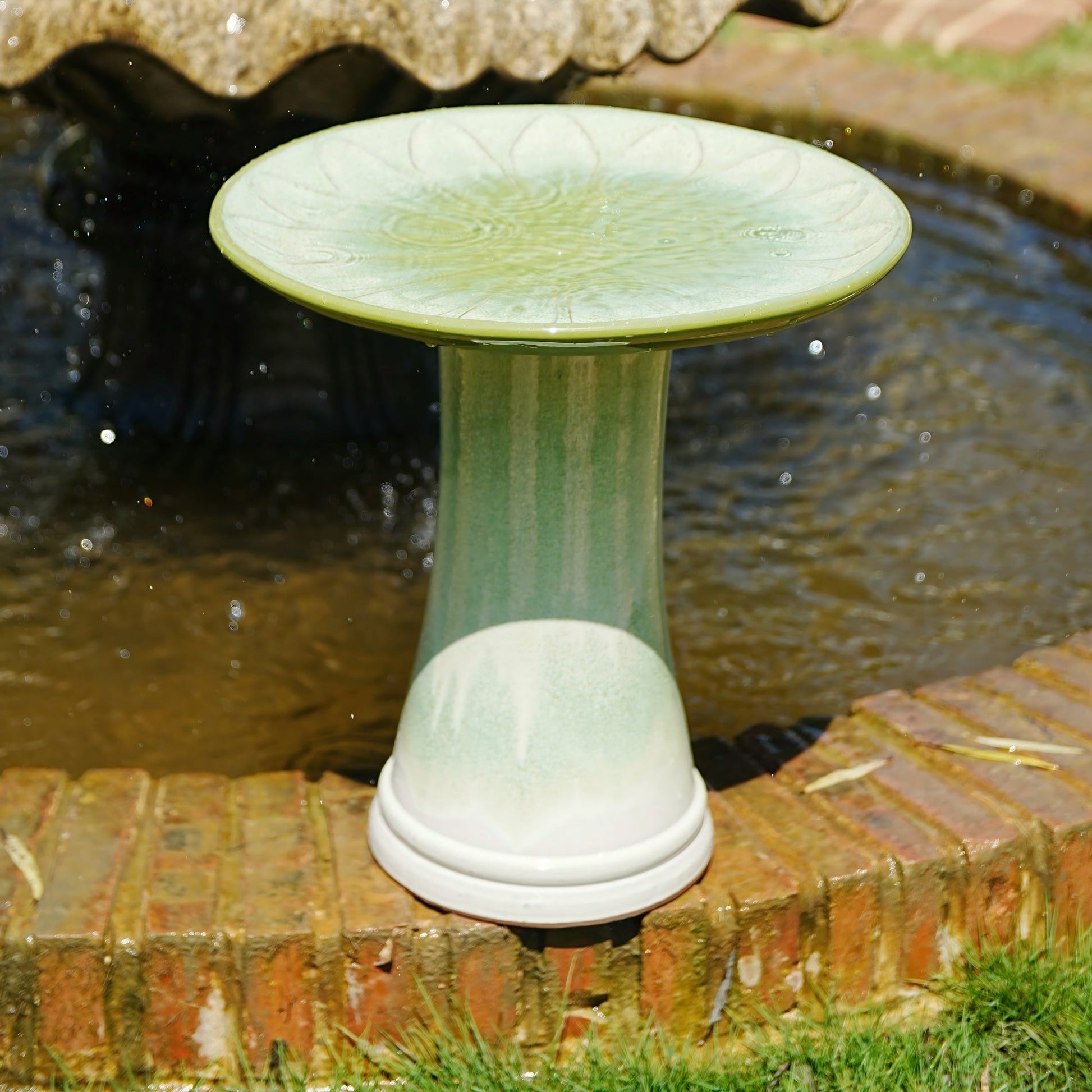 Handmade glazed ceramic bird bath with daisy-petal embossed tray, green glaze on pedestal on Tampa Home & Garden Store