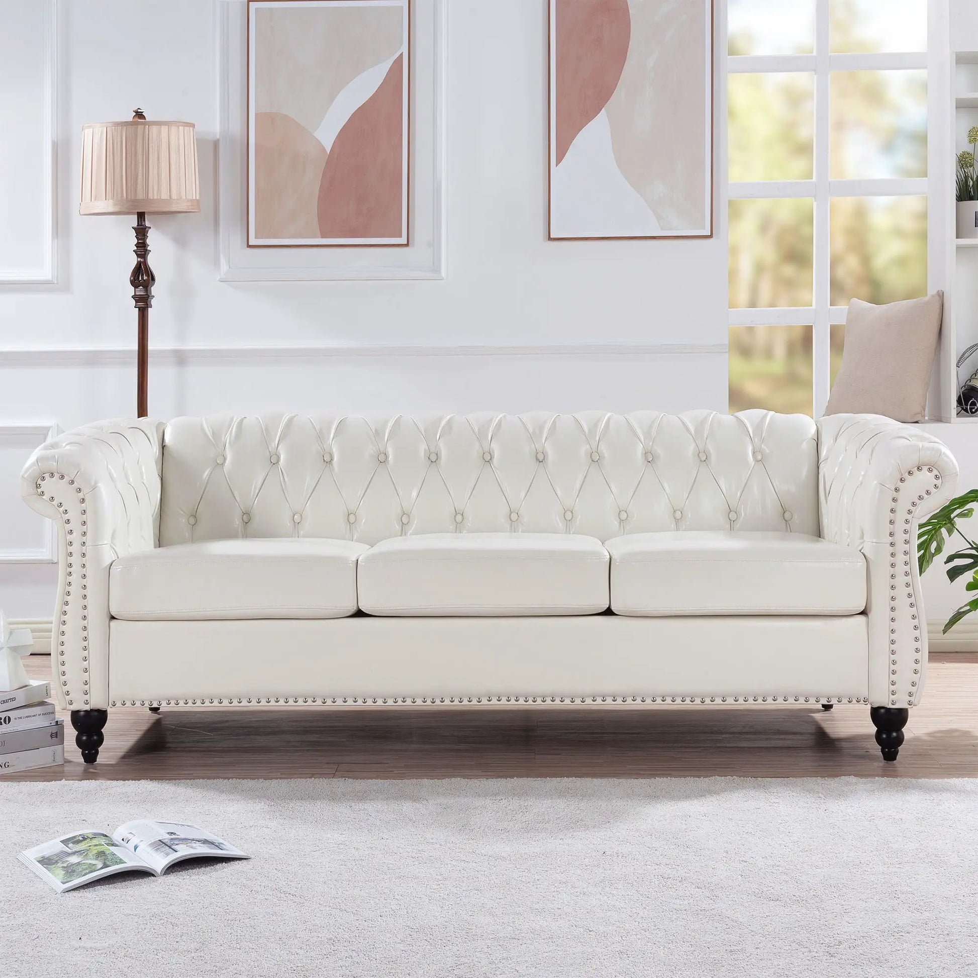 Rolled-arm Chesterfield 3-seater sofa in white tufted leather with nailhead trim in living room on Tampa Home & Garden Store