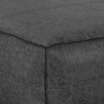 Brody large square coffee table pouf, dark gray faux leather with stitched panel seams on Tampa Home & Garden Store