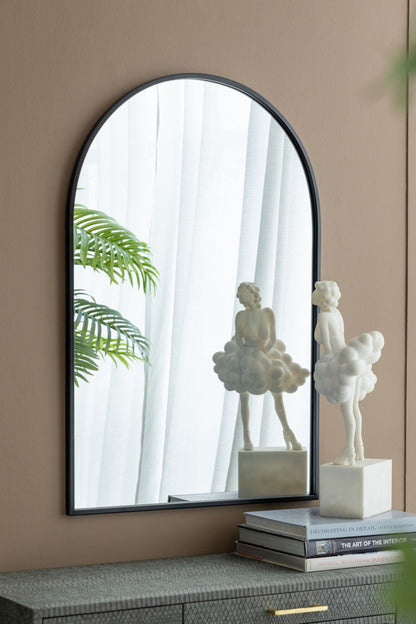 Arched mirror with black metal frame reflecting plant and cloud sculptures HouseOfZazla on Tampa Home & Garden Store