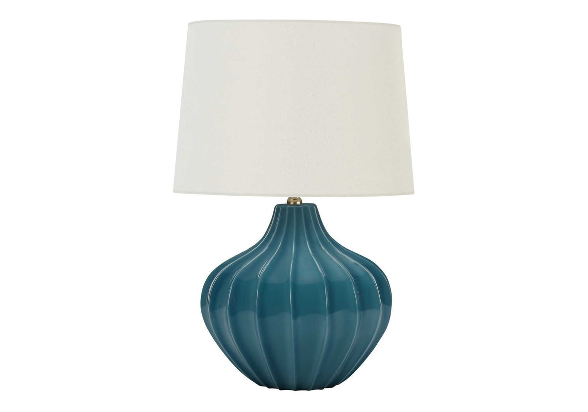 Blue ceramic table lamp with ribbed vase base, brass finial, and white fabric shade on Tampa Home & Garden Store