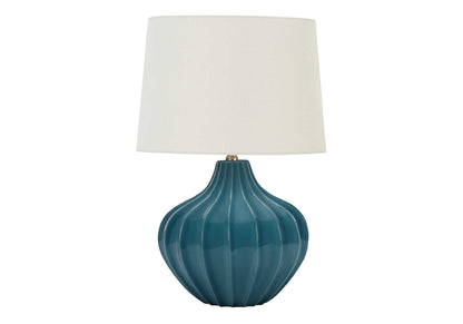 Blue ceramic table lamp with ribbed vase base, brass finial, and white fabric shade on Tampa Home & Garden Store