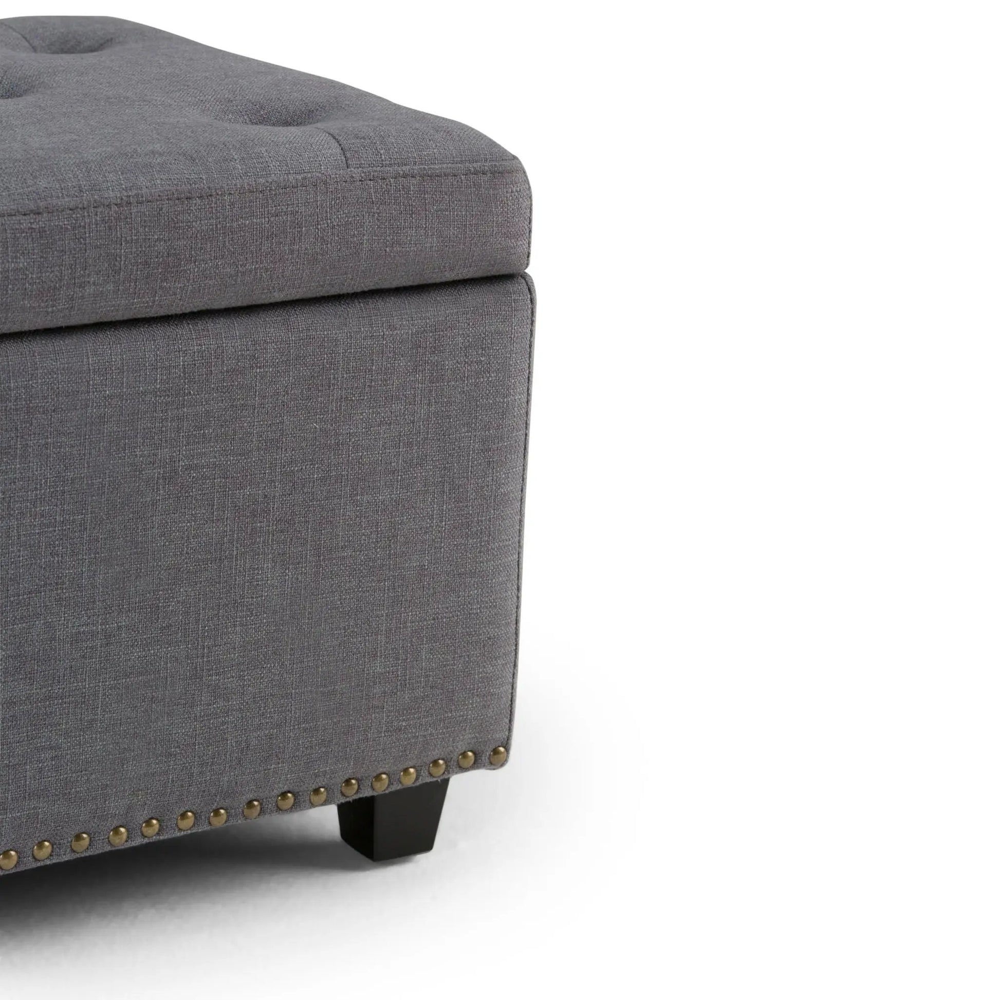 Hamilton Upholstered Storage Ottoman in gray fabric with brass nailhead trim on Tampa Home & Garden Store