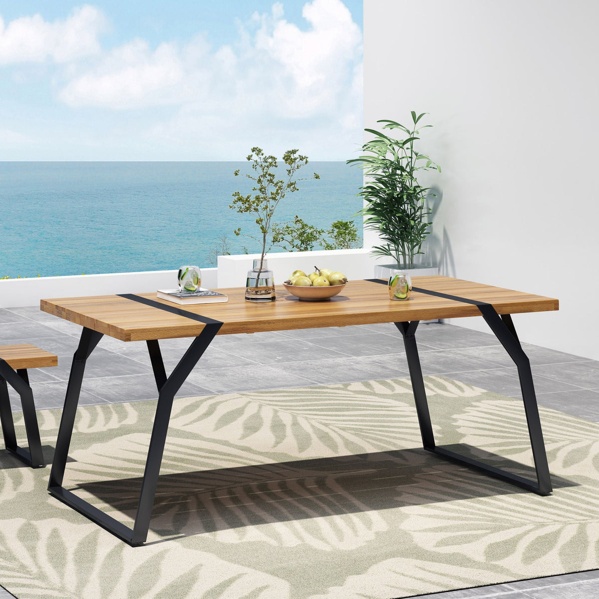 Zora dining table with weather-resistant acacia top and black iron legs outdoor setup on Tampa Home & Garden Store