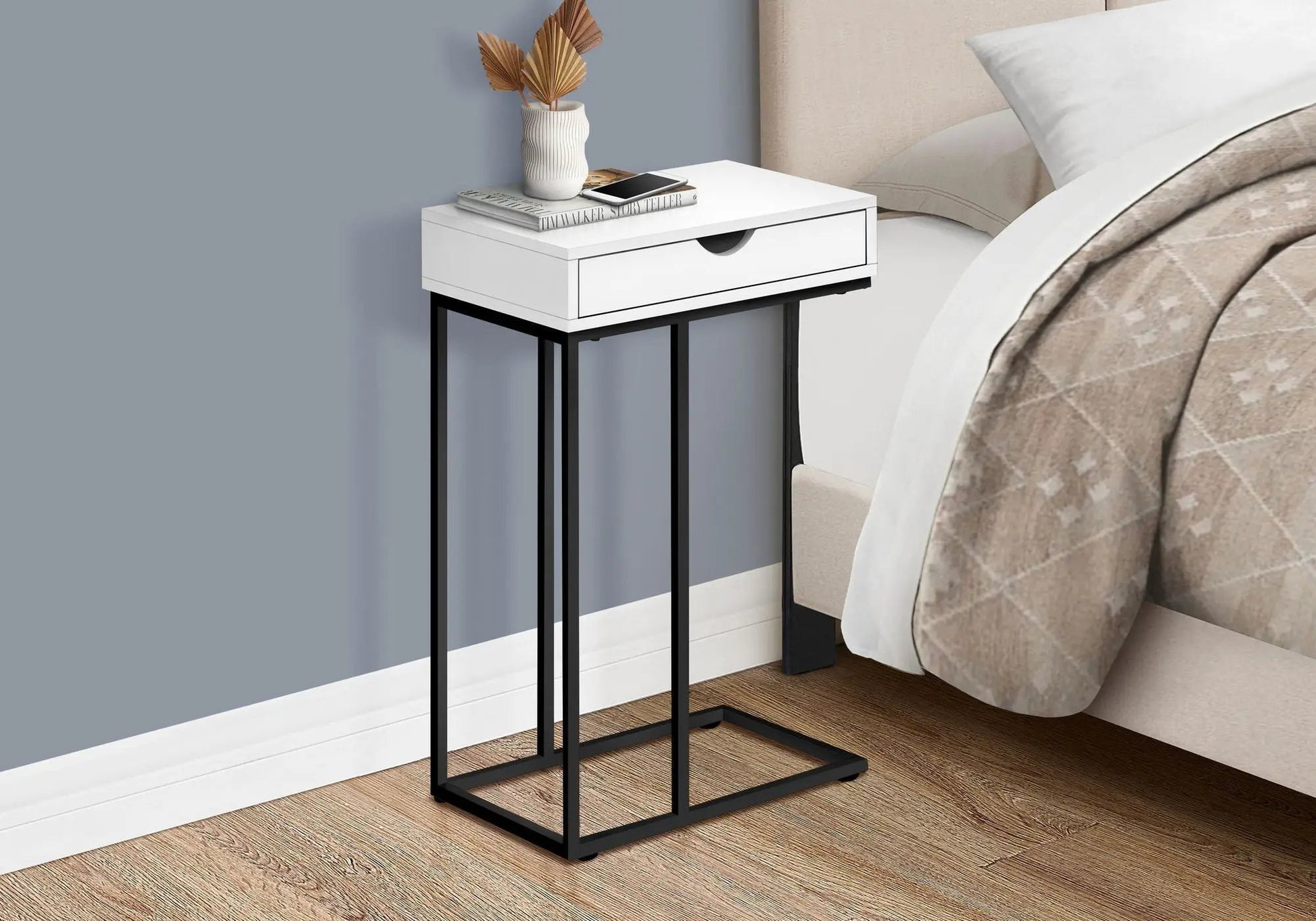 Accent Table C-shaped white drawer table with black metal legs in a bedroom setting, topped with vase, books, and smartphone on Tampa Home & Garden Store