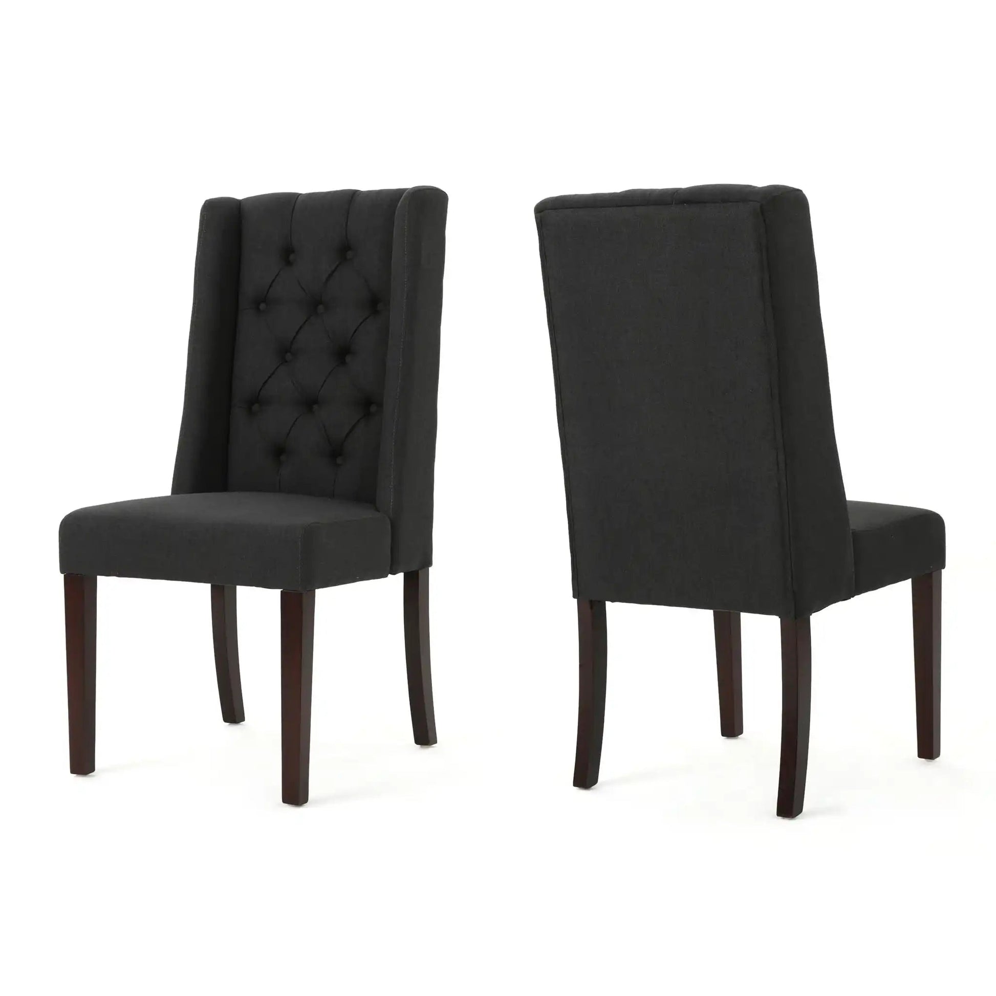 Two black tufted high-back dining chairs with dark wood legs, one with button tufting on Tampa Home & Garden Store