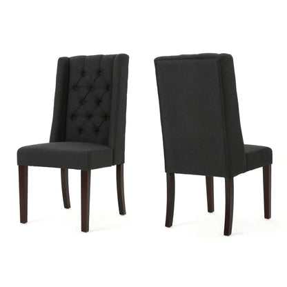 Two black tufted high-back dining chairs with dark wood legs, one with button tufting on Tampa Home & Garden Store