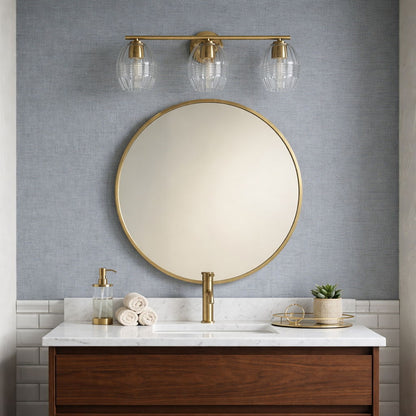 Luster 3-light vanity wall sconce with satin gold finish and clear glass shades above bathroom sink on Tampa Home & Garden Store