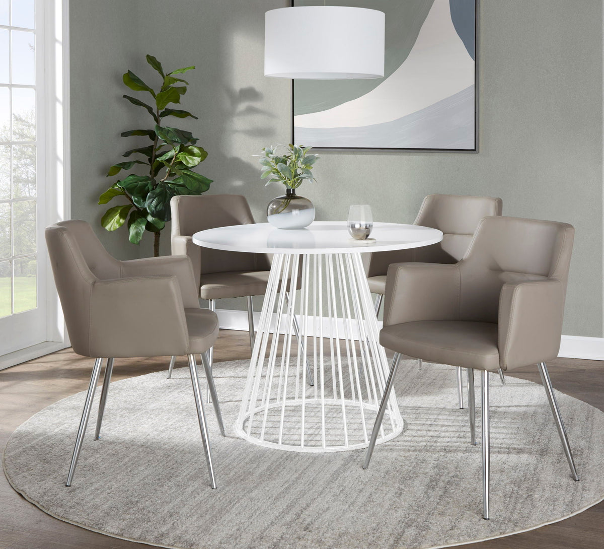 Contemporary white round dining table with metal base, four chairs in a modern dining room on Tampa Home & Garden Store