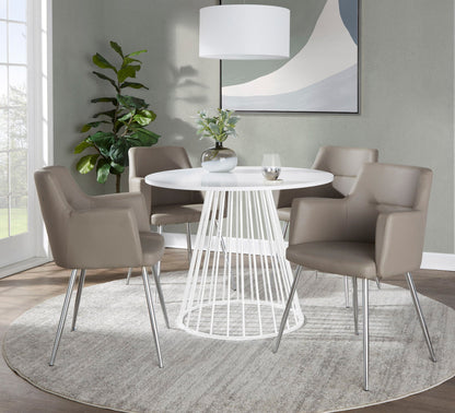 Contemporary white round dining table with metal base, four chairs in a modern dining room on Tampa Home & Garden Store