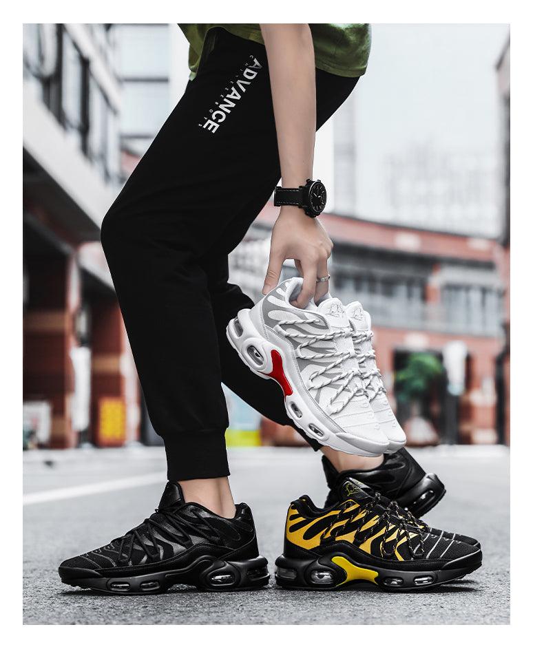 Stevvex Air Cushion sneakers white pair held; black/yellow and black sneakers on pavement on Tampa Home & Garden Store