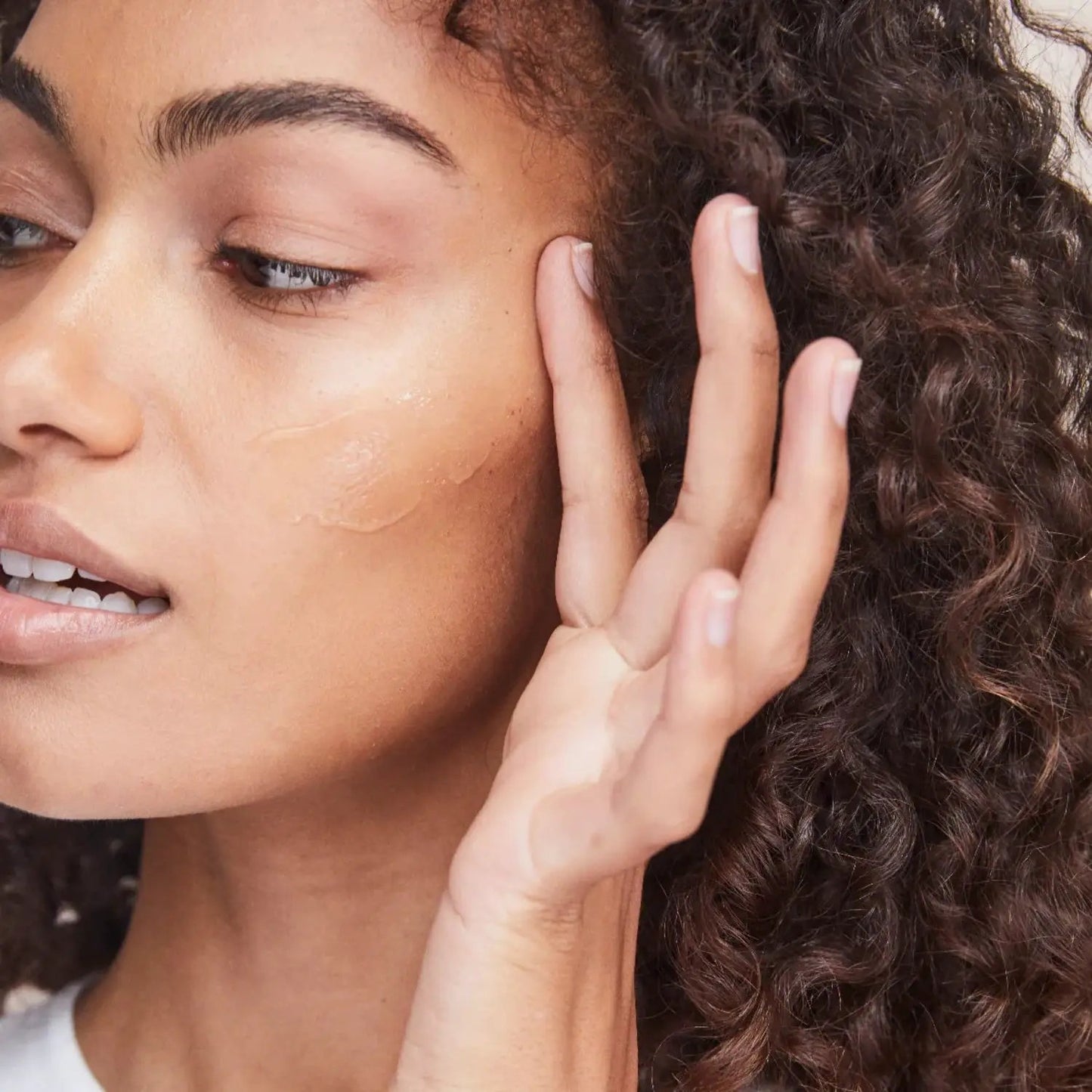 Alastin Skincare Regenerating Skin Nectar serum with TriHex Technology, clear gel on cheek on Tampa Home & Garden Store