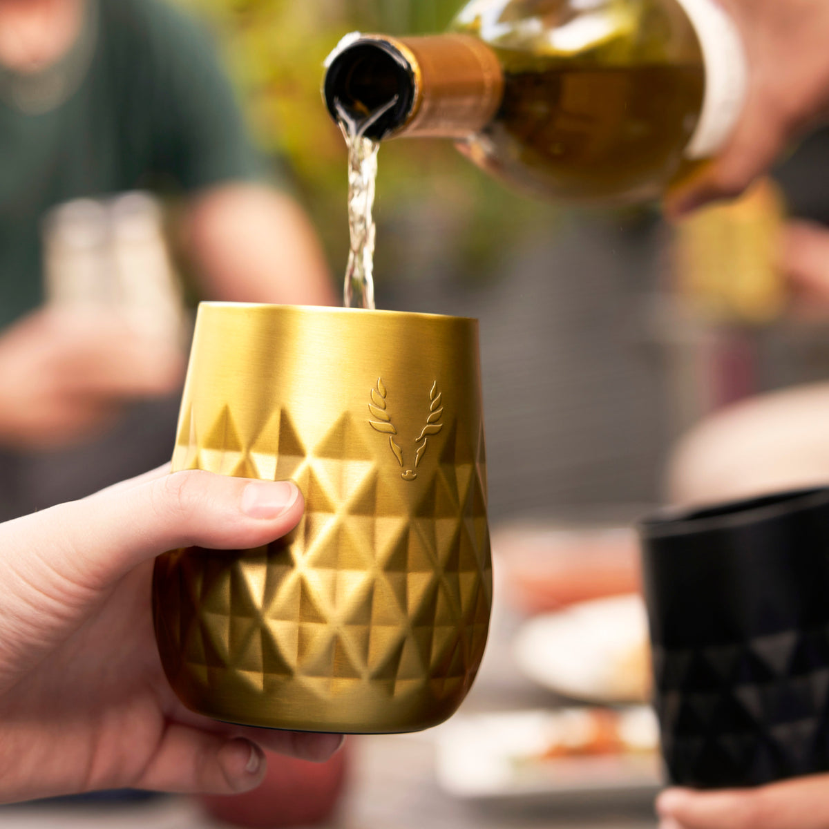 Paragon stainless steel wine tumbler gold with hammered diamond texture by Viski being poured on Tampa Home & Garden Store