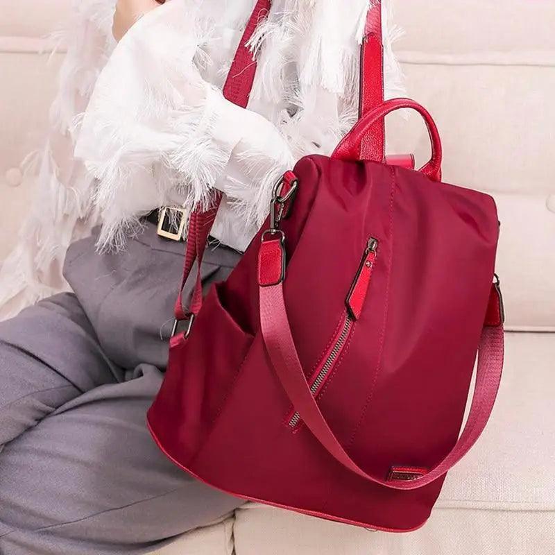 Stevvex anti-theft laptop backpack in waterproof maroon fabric with large capacity, top handle and adjustable strap on Tampa Home & Garden Store