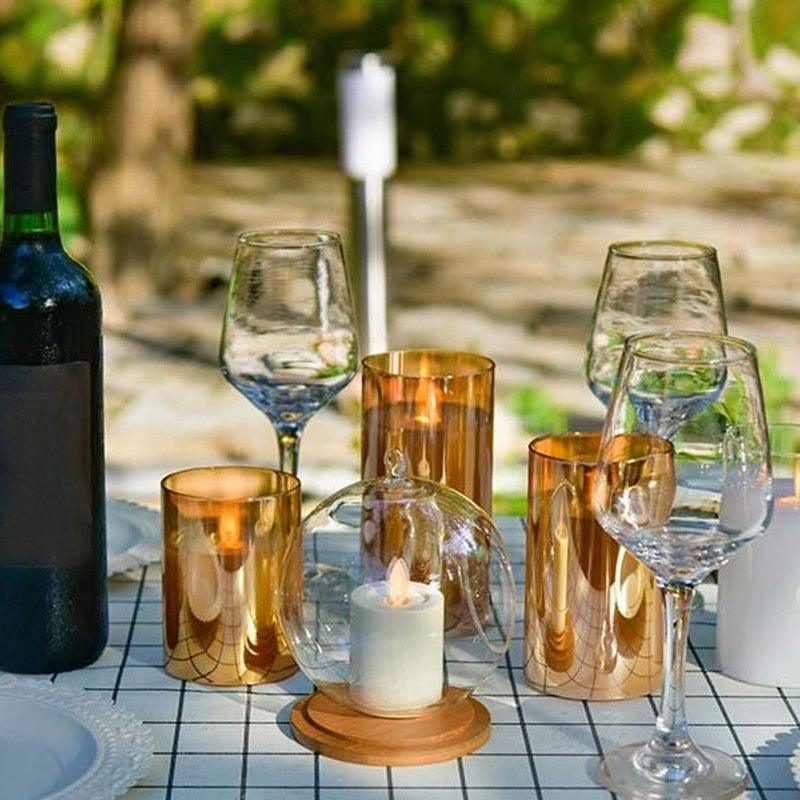 Amber glass LED flameless candle set with 4 gold pillar holders and a candle under glass on Tampa Home & Garden Store