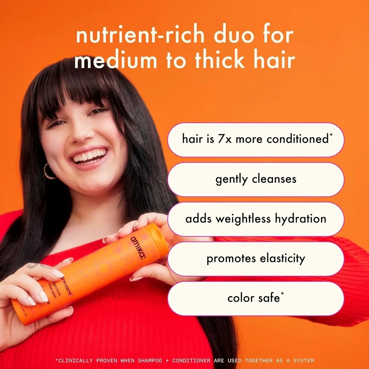Amika Normcore Hydrating Conditioner bottle held by woman on orange backdrop on Tampa Home & Garden Store