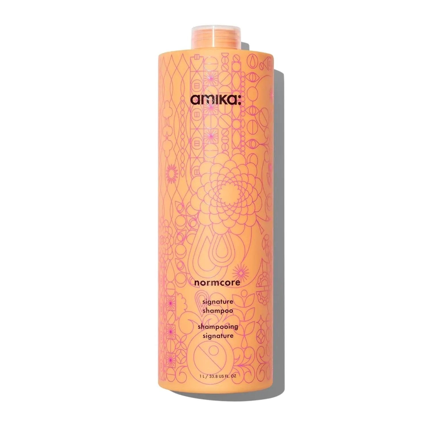 Amika Normcore Signature Shampoo bottle, peach-orange with pink geometric pattern, Nava Beauty on Tampa Home & Garden Store