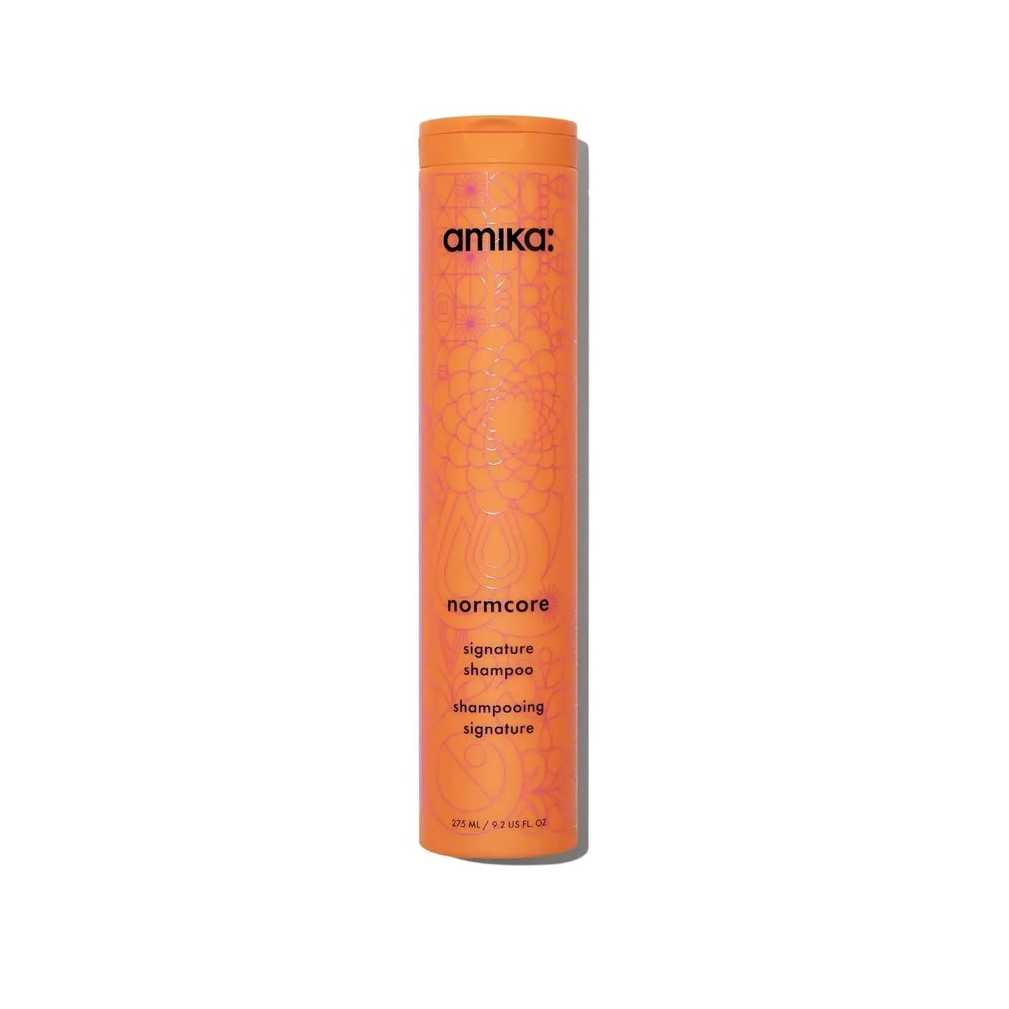 amika Normcore Signature Shampoo bottle, orange cylindrical container with pattern on Tampa Home & Garden Store