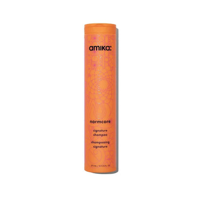 amika Normcore Signature Shampoo bottle, orange cylindrical container with pattern on Tampa Home & Garden Store