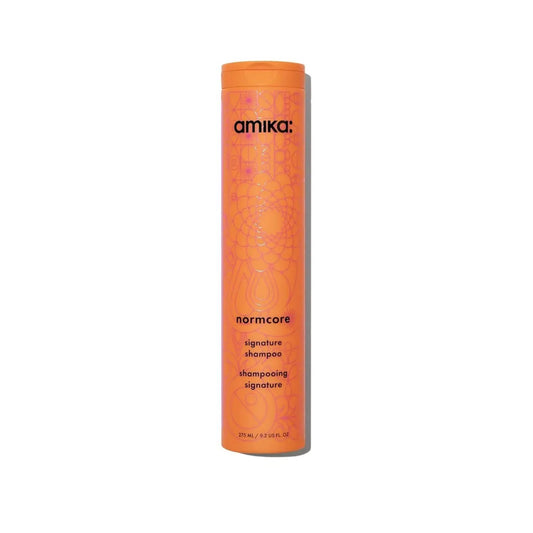 amika Normcore Signature Shampoo bottle, orange cylindrical container with pattern on Tampa Home & Garden Store
