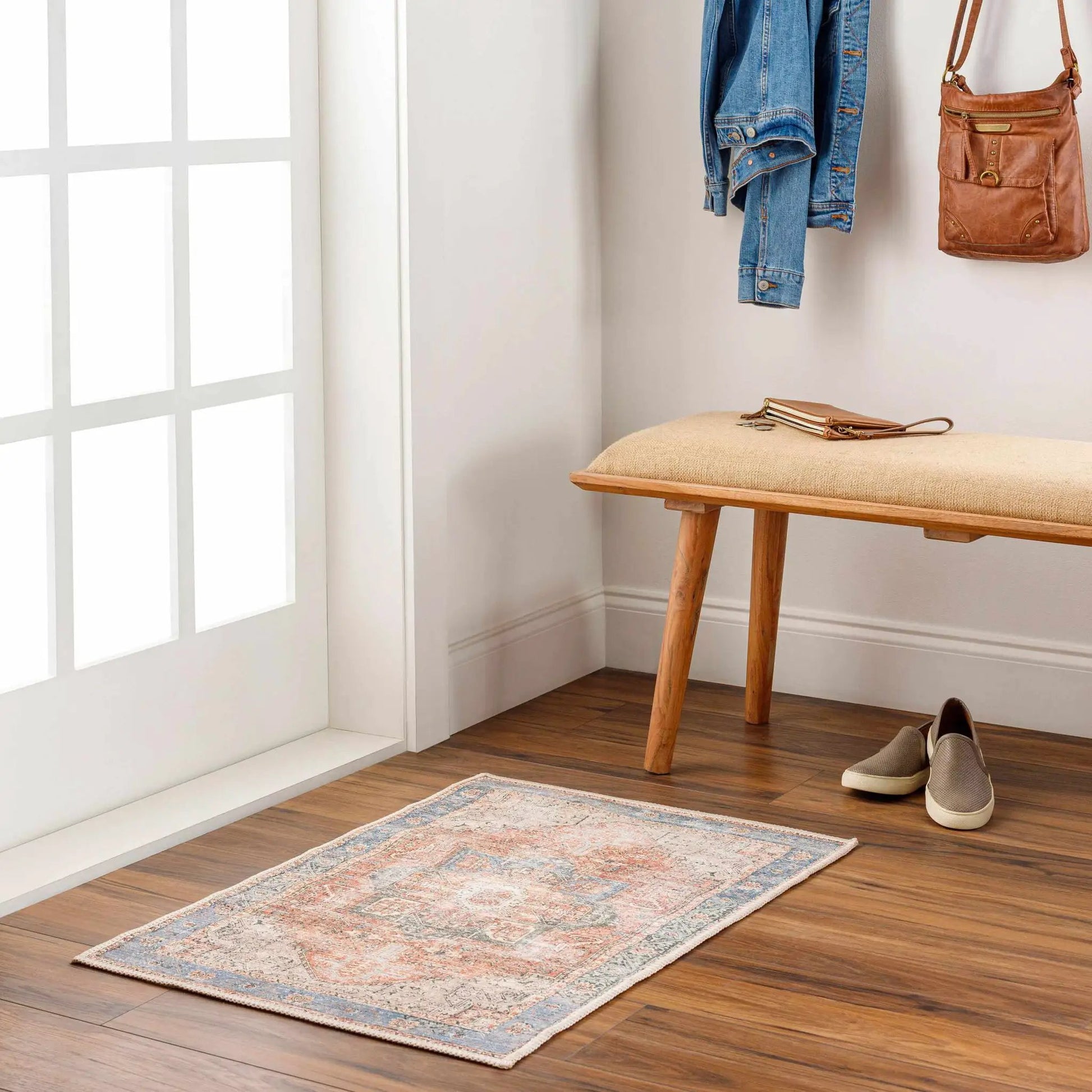 Rosman Distressed Washable Area Rug by Boutique Rugs in an entryway with multicolor pattern on Tampa Home & Garden Store