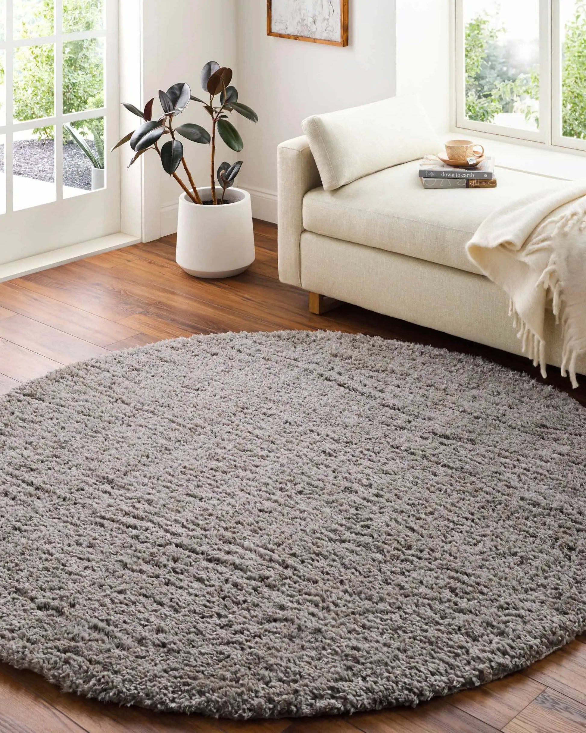 Siari solid gray shag rug in a bright living room with a cream sofa on Tampa Home & Garden Store