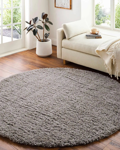 Siari solid gray shag rug in a bright living room with a cream sofa on Tampa Home & Garden Store