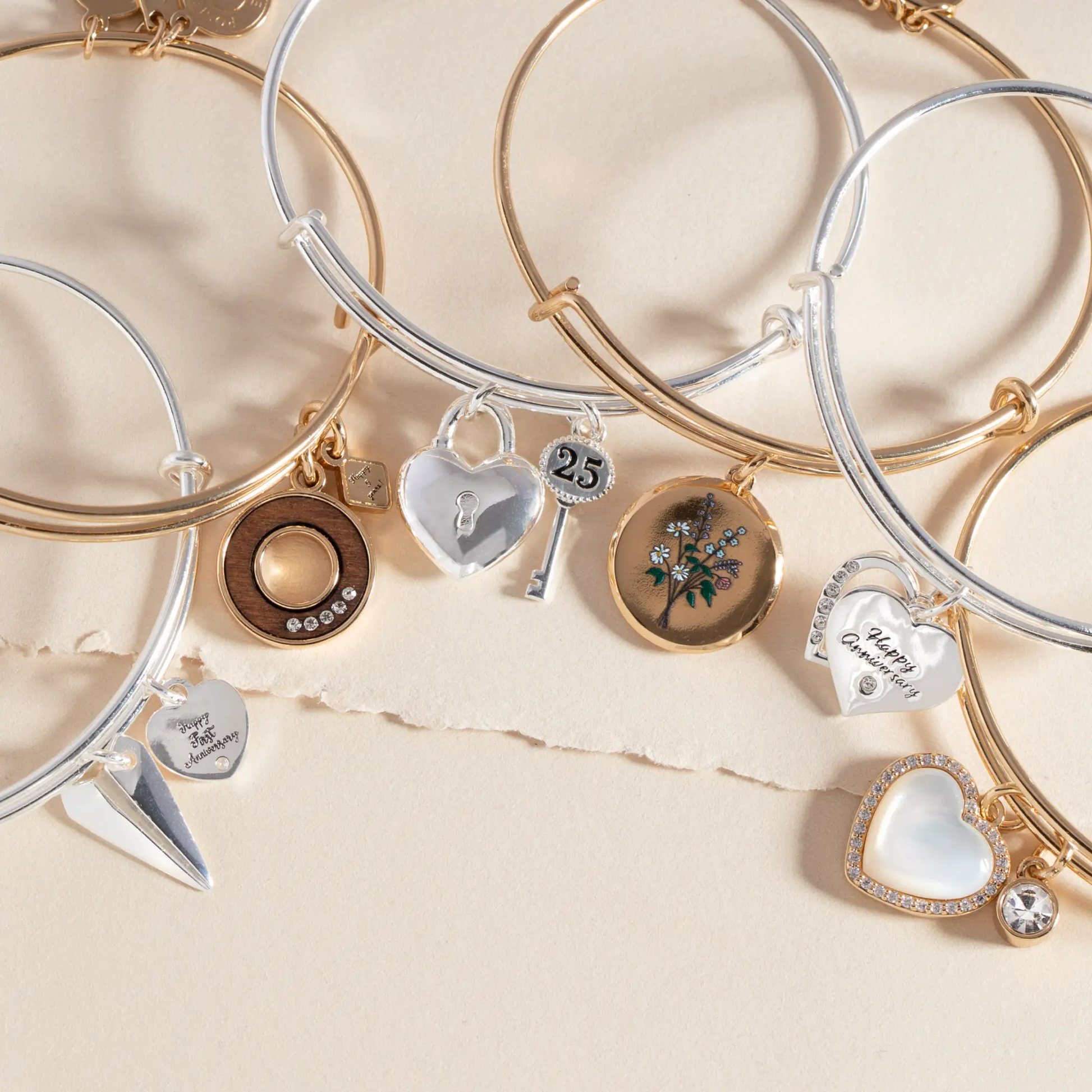 25th Anniversary Bangle set of gold and silver-tone bracelets with heart and 25 charms on Tampa Home & Garden Store