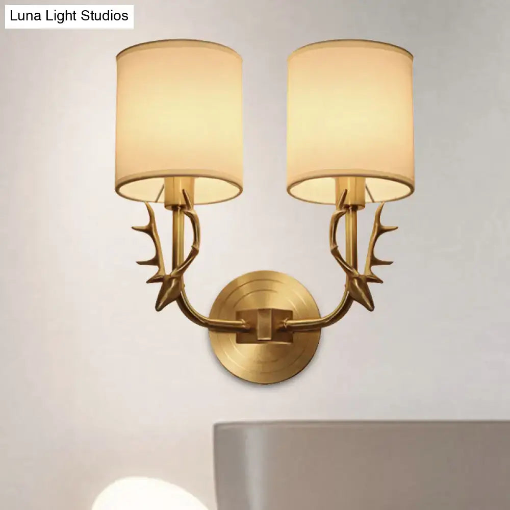 Antique brass fabric sconce with twin shades and antler arms Decorbites Luna Light Studios on Tampa Home & Garden Store