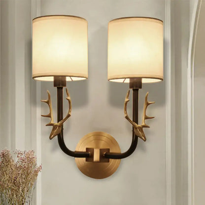 Antique Brass Fabric Sconce, twin lights with antler-brass arms and cream drum shades on Tampa Home & Garden Store