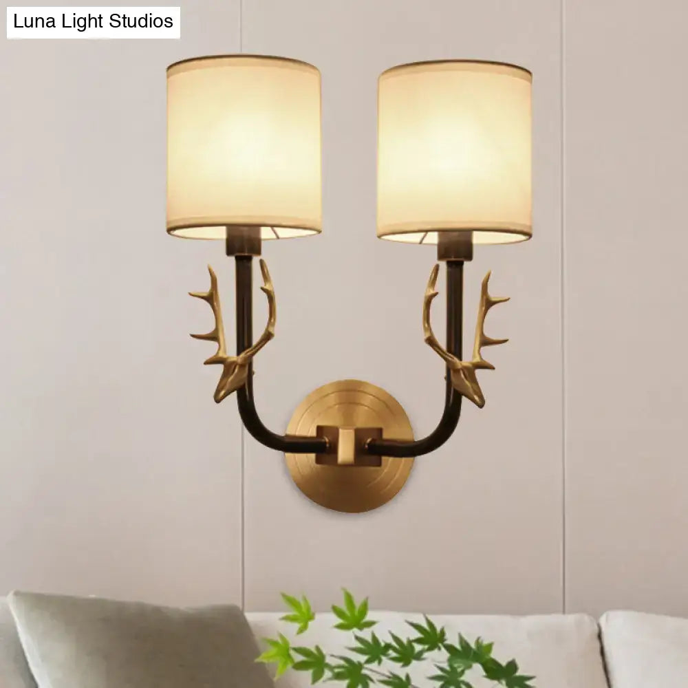 Antique Brass Fabric Sconce Decorbites with twin antler arms and shades on wall mount on Tampa Home & Garden Store
