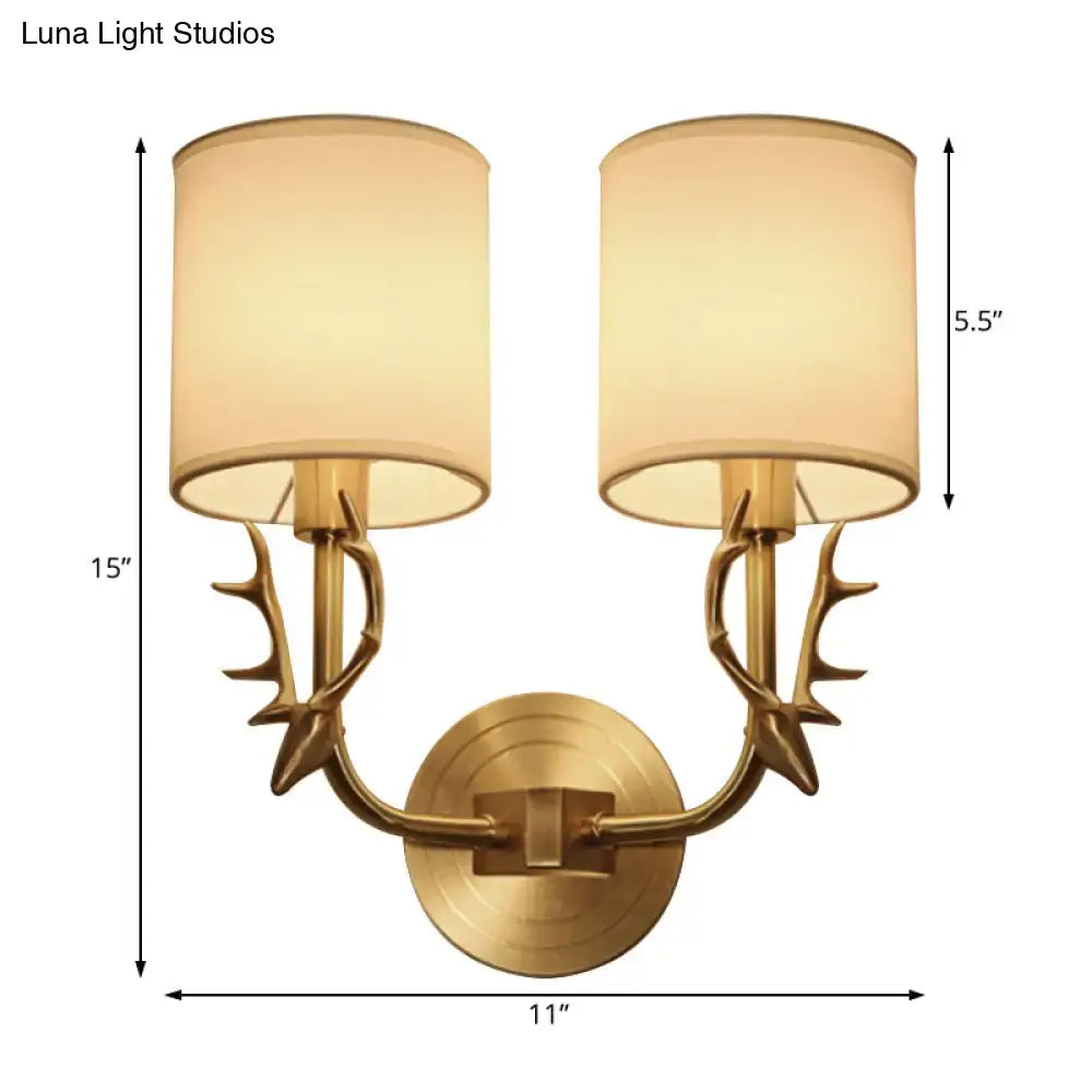 Antique Brass Fabric Sconce Decorbites with dual antler arms and cream fabric shades on Tampa Home & Garden Store