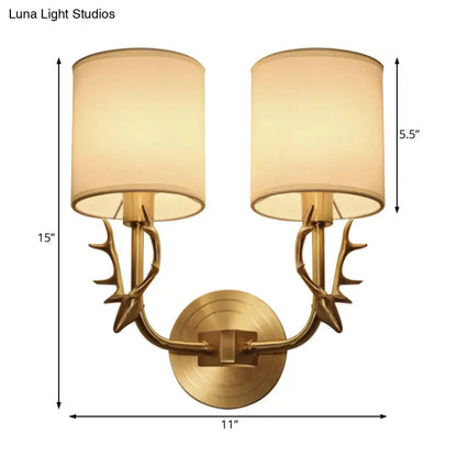 Antique Brass Fabric Sconce Decorbites with dual antler arms and cream fabric shades on Tampa Home & Garden Store