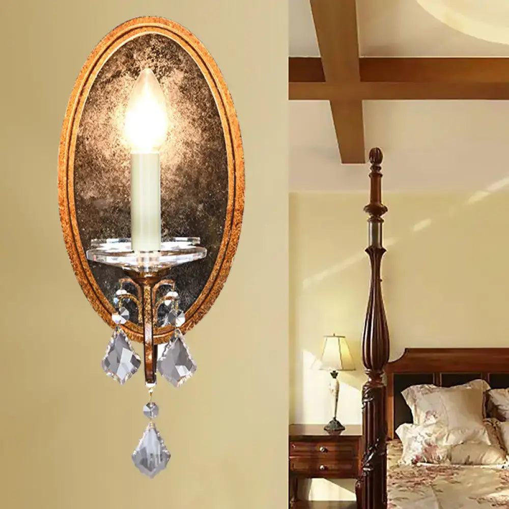 Antique brass candle-style wall sconce by Decorbites with mirror backplate and crystal drops on Tampa Home & Garden Store