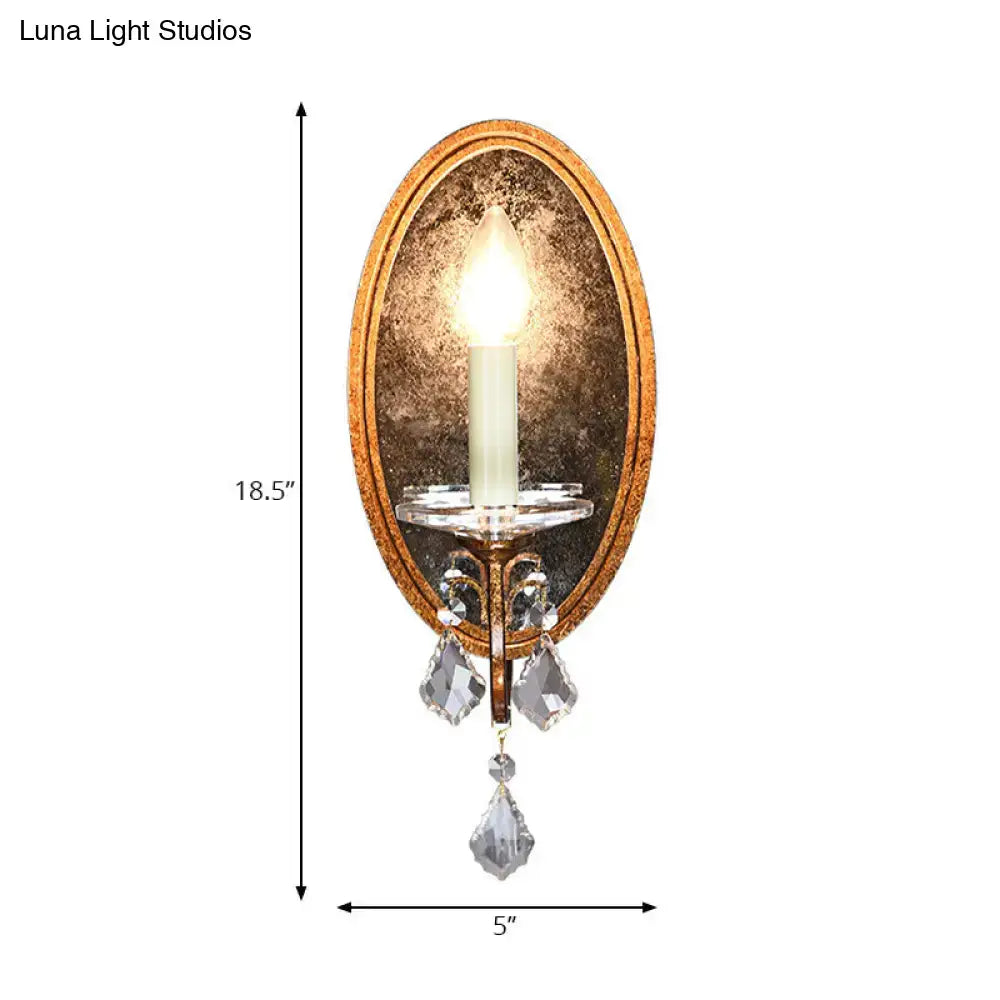 Antique brass candle-style wall sconce with oval backplate and crystal drops Decorbites on Tampa Home & Garden Store