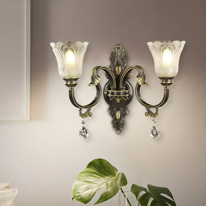 Brass floral black gold wall sconce with double curved arms, glass shades and crystal drops on Tampa Home & Garden Store