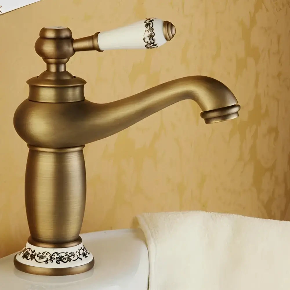 Bronze ceramic-handle bathroom faucet by Decorbites with ornate white handle and curved spout on Tampa Home & Garden Store