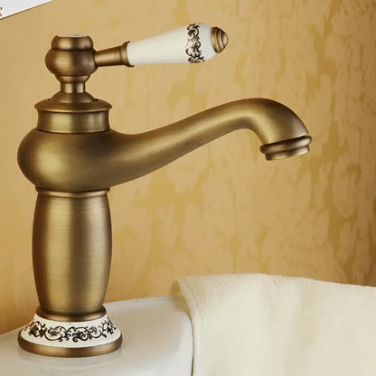 Bronze ceramic-handle bathroom faucet by Decorbites with ornate white handle and curved spout on Tampa Home & Garden Store