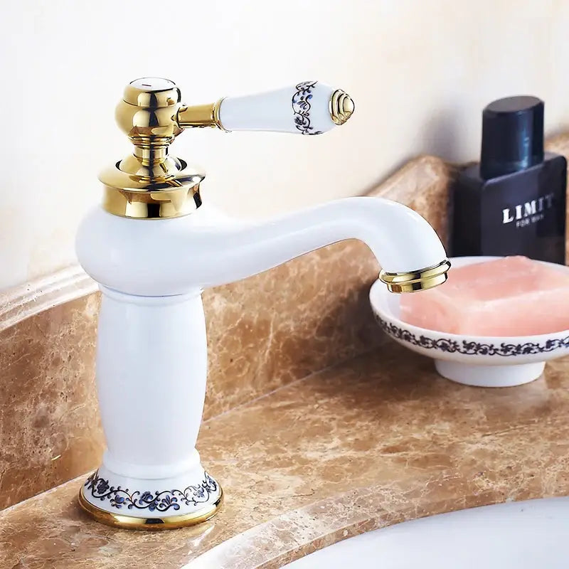 Bronze ceramic handle faucet; white ceramic body with gold trim and blue-pattern handle on Tampa Home & Garden Store