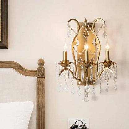 Gold crystal candelabra light wall sconce with two candle bulbs and dangling crystal prisms on Tampa Home & Garden Store