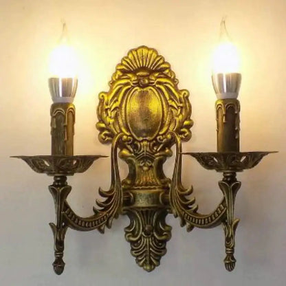 Gold retro wall sconce with ornate brass finish and two candle bulbs on Tampa Home & Garden Store