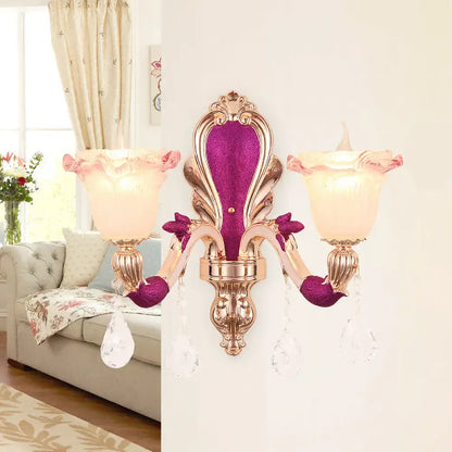 Gold double-head sconce with pink velvet back, crystal drops, and pink glass shades on Tampa Home & Garden Store