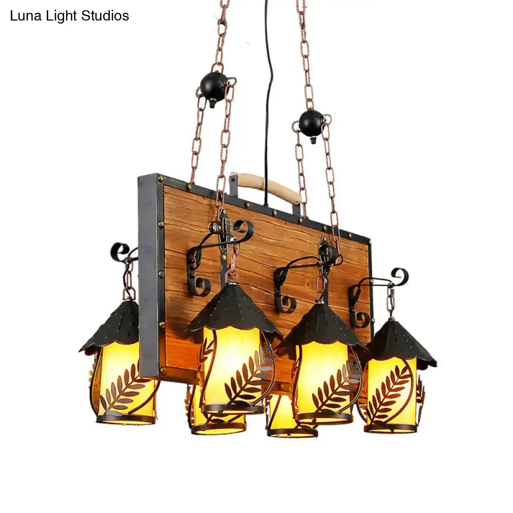 White Glass Chandelier five amber-glass lanterns on a wood backboard with black metal accents on Tampa Home & Garden Store