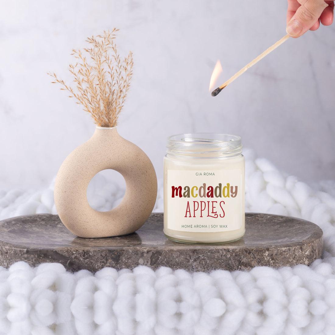 Macdaddy Apples candle by Gia Roma in a glass jar, soy wax, beside a beige vase with pampas on Tampa Home & Garden Store
